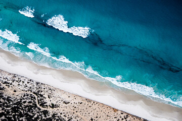 Aerial view of successive waves crashing against beach