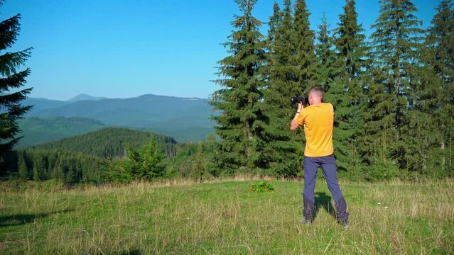 Talented photographer creates incredible photos in mountains. Take stunning pictures of landscape. Nature photographer taking authentic outdoor photos in the bright sunny day. Picturing beautiful view