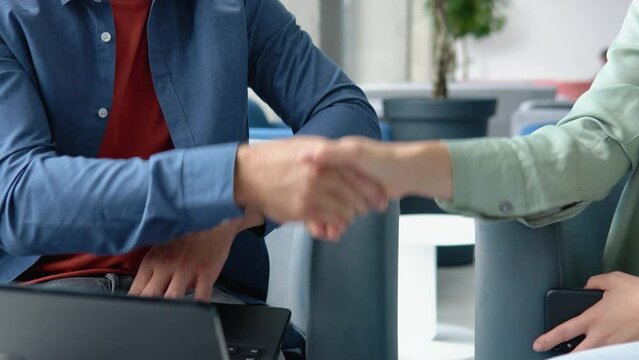 Close-up of shaking hands after a business meeting in the office