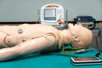 Simulated patient, defibrillator electrods, performing defibrillation or electropulse therapy, CPR model - obrazy, fototapety, plakaty
