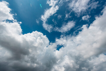 Naklejka na ściany i meble Blue sky fluffy white clouds on summer season bright clear skyline with beautiful cloudscape. Panorama blue sky clouds pattern on daylight with copy space. Cumulus cloudscape air climate sunny day