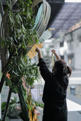 Traditional decoration for special event with coloured banana leaf and greens for backdrop or...