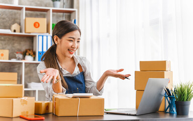 Entrepreneurs Small Business SME, Young Asian women happy after a new order from the customer, business owner working at home office.