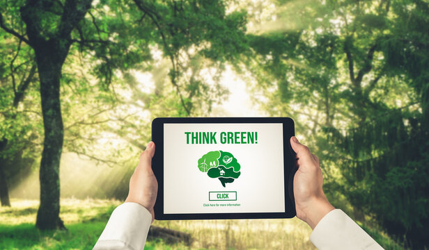 Green business transformation for environment saving and ESG business concept. Businessman using tablet to set corporate goal toward environmental friendly management and alternative clean energy use.
