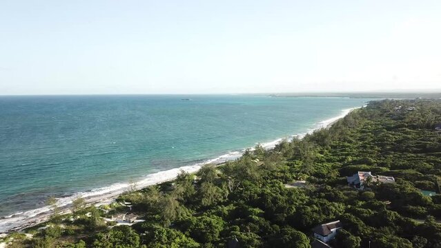 Birds eye view of beautiful tropical coastal scenery, seascape of long beach and green rainforest. Watamu, Kenya