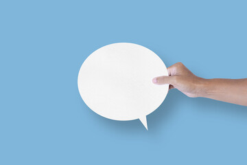 hand holding round white paper balloons speech bubbles isolated on light blue background