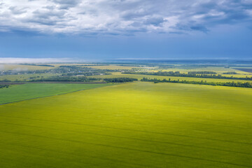 Rural landscape. Aerial view of a field with sunlight on it on rainy summer day. Penza Oblast,...