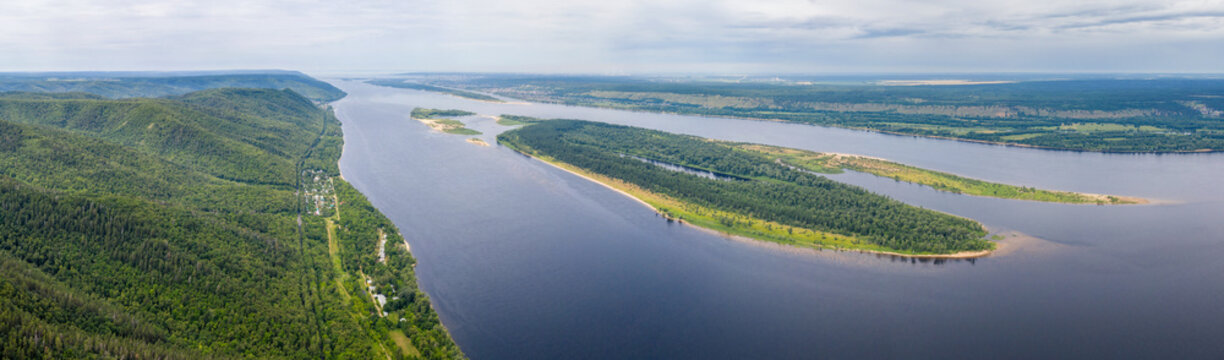 Panoramic aerial view of Zhiguli mountains, Volga river and Sredniy island on sunny summer day. Zhiguli Nature Reserve, Samara Oblast, Russia.