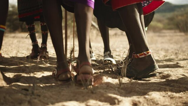 Legs Of Tribal People Dancing On Sand In Desert - Nairobi, Kenya