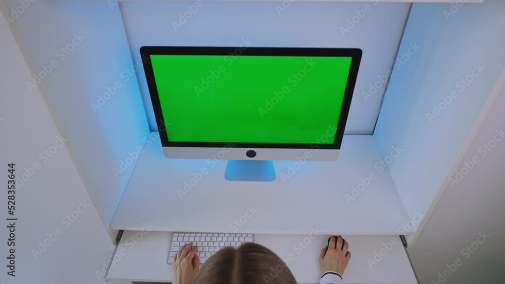 Poster above view businesswoman sitting at the workplace display computer with green screen working at home