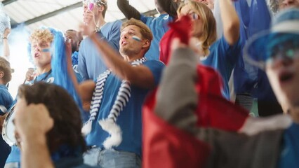 Sport Stadium Big Event: Crowd of Fans Cheer for Blue Soccer Team to Win. People Celebrate Scoring a Goal, Championship Victory. Cute Caucasian Couple with Painted Faces Cheer, Shout, Beat the Drum