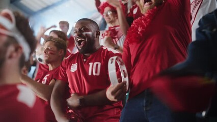 Sport Stadium Soccer Match: Diverse Crowd of Fans Cheer for their Red Team to Win. People Celebrate Scoring a Goal, Championship Victory. Group People with Painted Faces Cheer, Shout, Have Fun
