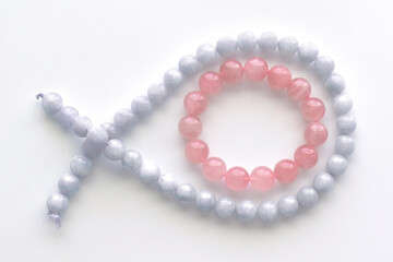 Rose quartz bracelet and aquamarine strand on the table.