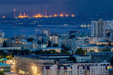 Fototapeta premium View of Saratov and shining Oil Refinery at night. Saratov Oblast, Russia.