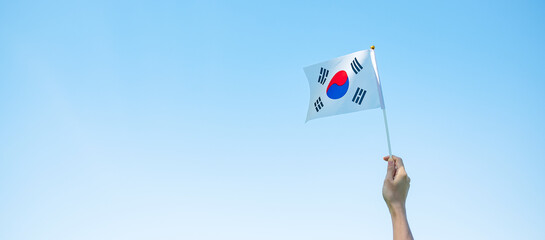 hand holding Korea flag on nature background. National Foundation, Gaecheonjeol, public Nation...