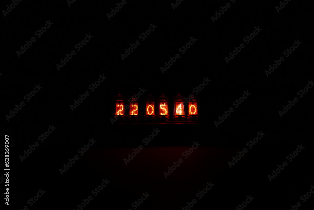 Poster retro nixie lamp indicator clock on dark background. the nixie tube indicator of the numbers of retr