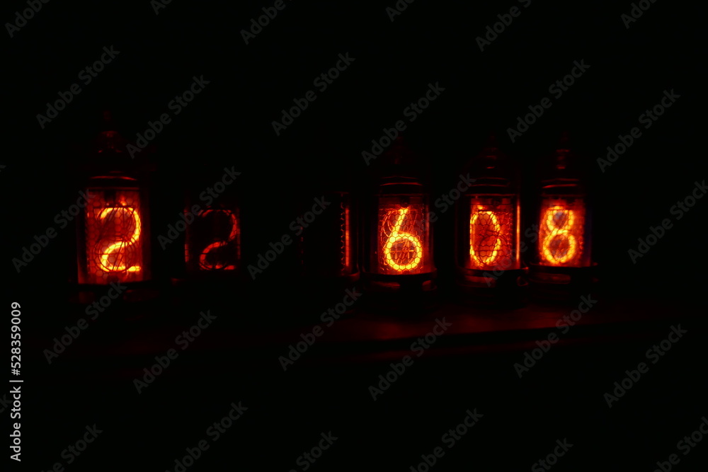 Poster retro nixie lamp indicator clock on dark background. the nixie tube indicator of the numbers of retr