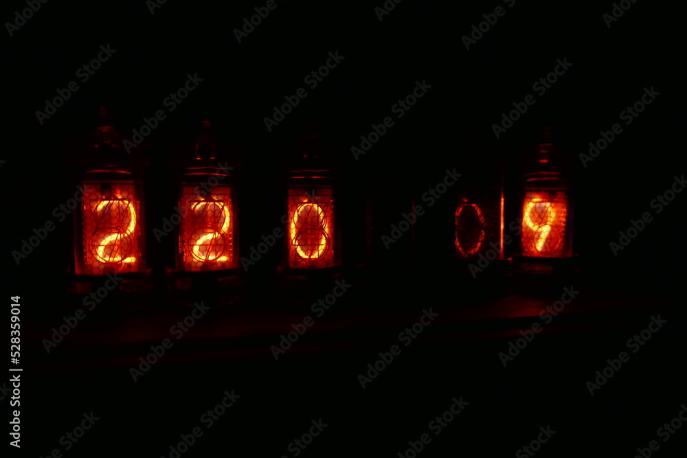 Poster retro nixie lamp indicator clock on dark background. the nixie tube indicator of the numbers of retr