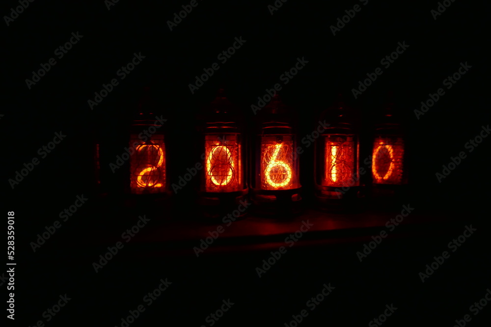 Poster retro nixie lamp indicator clock on dark background. the nixie tube indicator of the numbers of retr