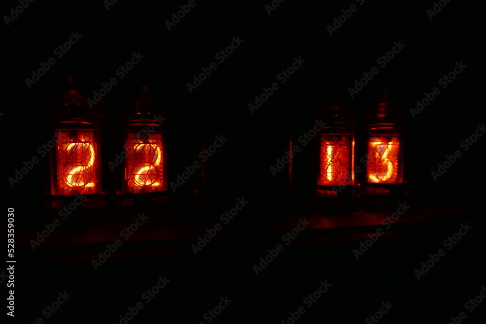 Poster retro nixie lamp indicator clock on dark background. the nixie tube indicator of the numbers of retr