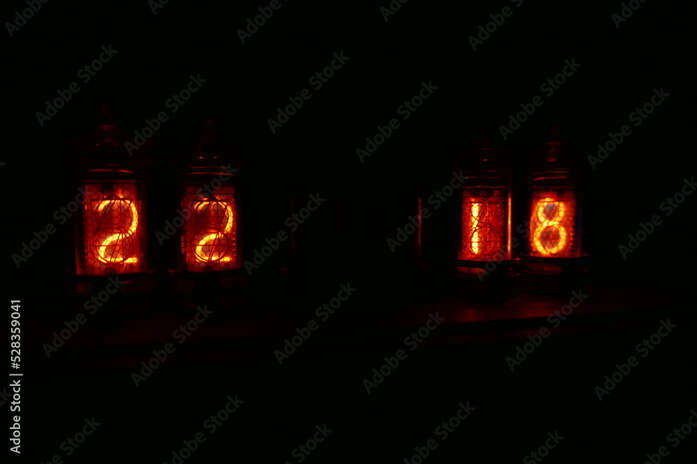 Poster retro nixie lamp indicator clock on dark background. the nixie tube indicator of the numbers of retr