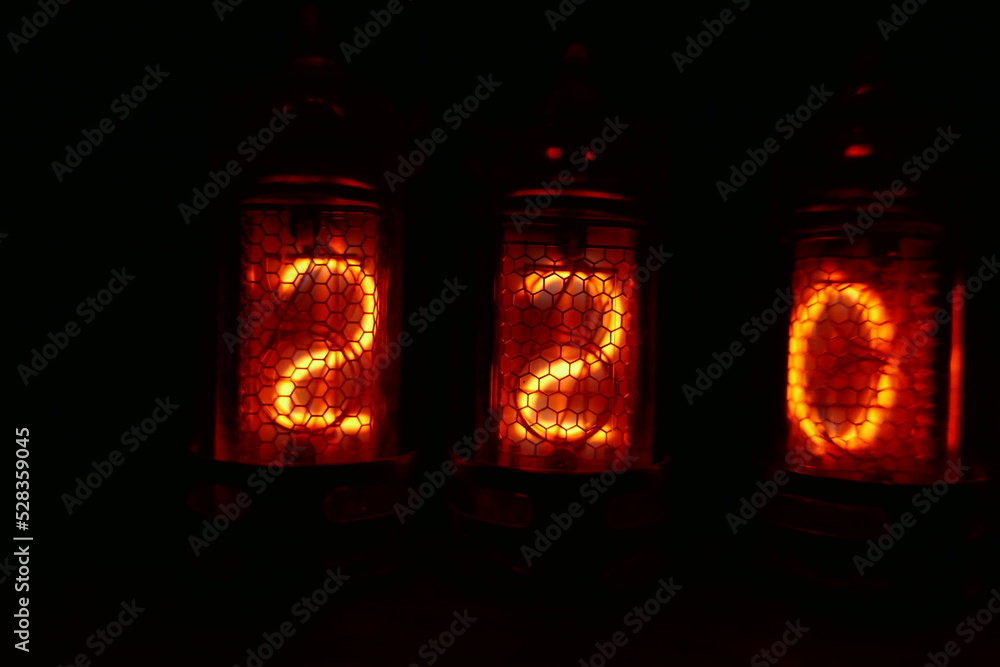 Poster retro nixie lamp indicator clock on dark background. the nixie tube indicator of the numbers of retr