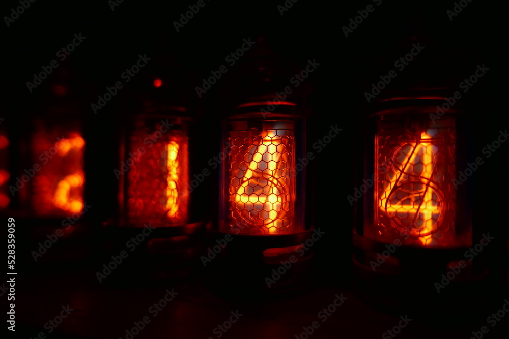 Poster retro nixie lamp indicator clock on dark background. the nixie tube indicator of the numbers of retr