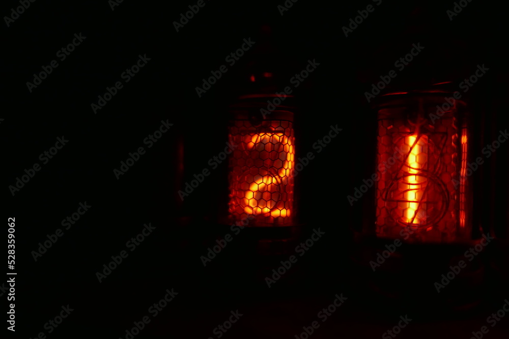 Poster retro nixie lamp indicator clock on dark background. the nixie tube indicator of the numbers of retr