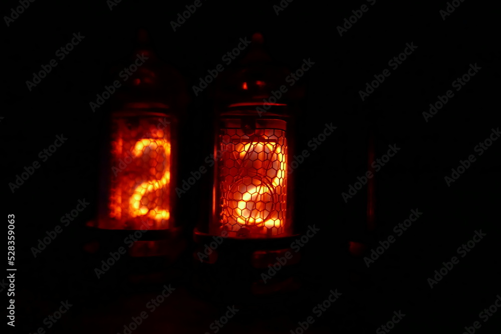 Poster retro nixie lamp indicator clock on dark background. the nixie tube indicator of the numbers of retr