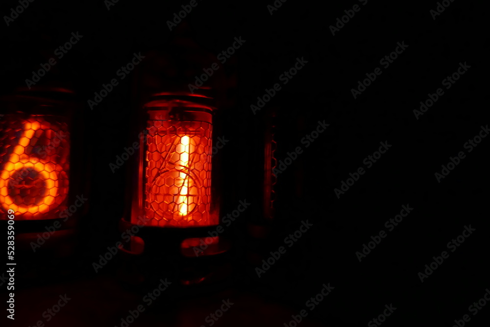 Poster retro nixie lamp indicator clock on dark background. the nixie tube indicator of the numbers of retr
