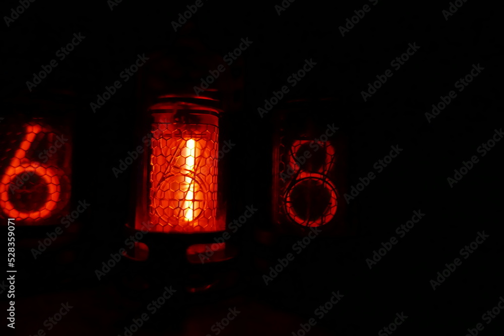 Poster retro nixie lamp indicator clock on dark background. the nixie tube indicator of the numbers of retr