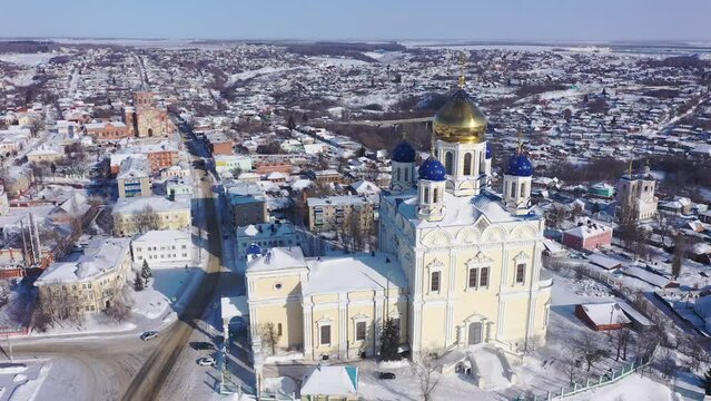 Aerial view of the Ascension Cathedral, located in the historical center of the city on the Red Square of Yelets, and the surrounding his residential areas in winter, Russia. 