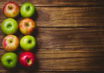 Red and green apples on table