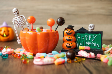 Happy Halloween day with ghost candies, pumpkin bowl, Jack O lantern and decorative (selective...