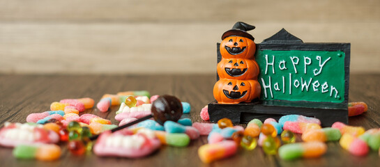 Happy Halloween day with ghost candies, pumpkin bowl, Jack O lantern and decorative (selective...