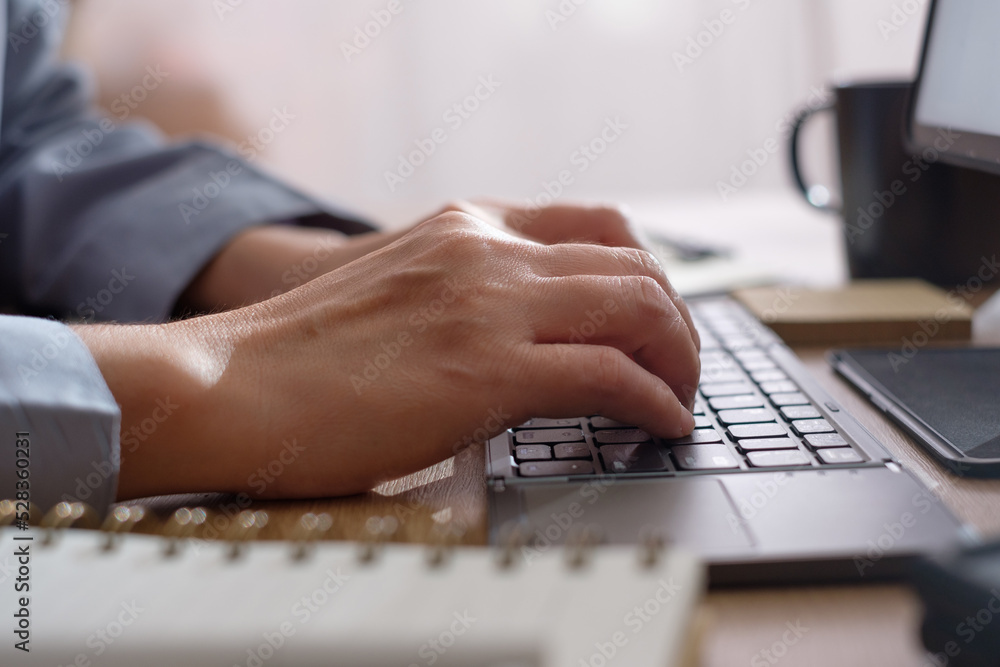 Poster close up hand typing on keyboard when woking at home