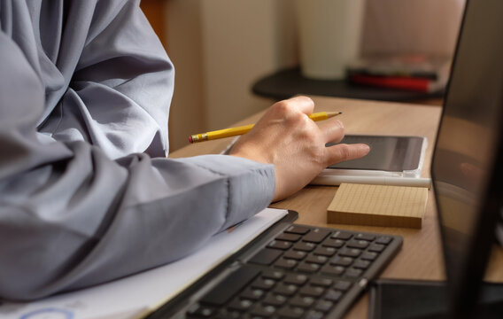 close up hand using tablet view data when video conference at home