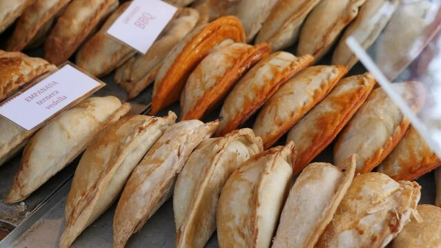 Closeup of baked snack empanada at market, popular spanish street food