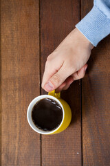 Man holding yellow coffee cup