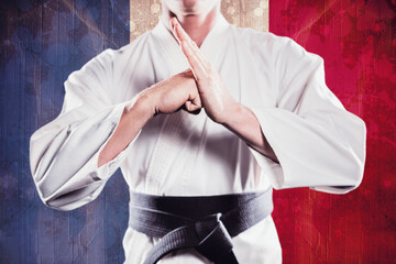 Midsection of martial artist practicing against French Flag