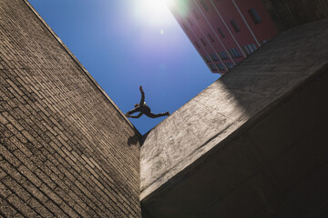 Caucasian man jumping from building