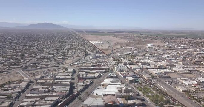 Drone flying to the right over a Mexico aside the border of the United States of America