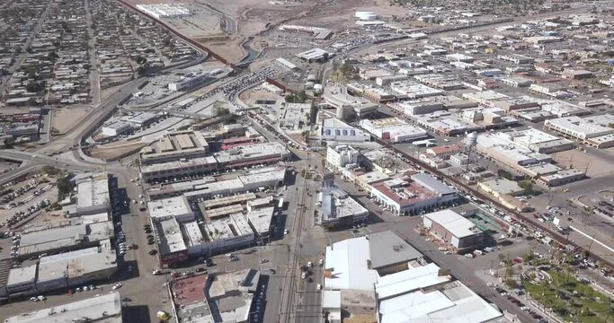 Drone flying slightly to the right over Mexico aside the border of the United States of America