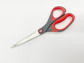 Scissors with red plastic handles, open and closed, on a white background