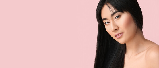 Young Asian woman with beautiful long hair on pink background with space for text