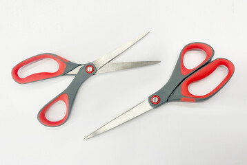 Scissors with red and gray plastic handles, Scissors open and closed, on a white background