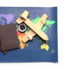 World map, passports, wooden airplane and compass isolated on white background
