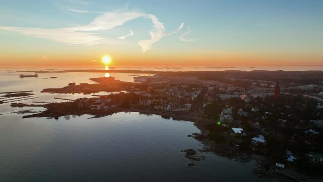 Aerial view overlooking the cityscape of Hanko, spring sunset in Finland - circling, drone shot