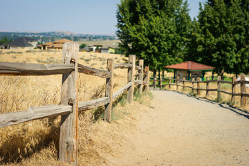 Fototapeta na wymiar Wooden fence along footpath