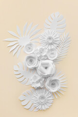 Paper flowers with leaves on light background